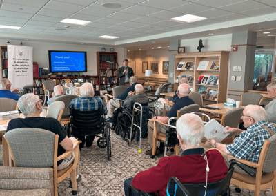 elderly men listen to presentation