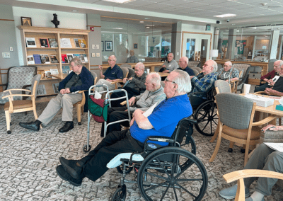 elderly men listen to presentation