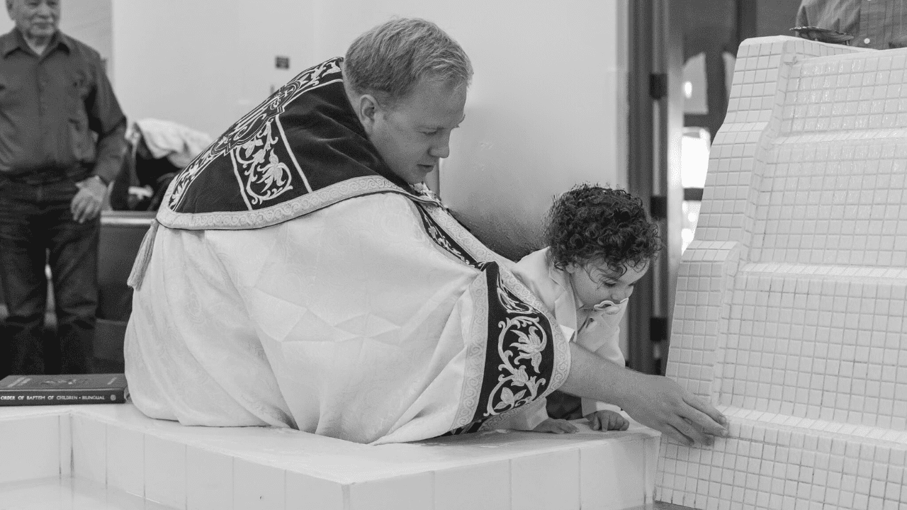 Fr. Andrew Fritz baptising a child at St. John Vianney in Goodyear, AZ